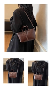 Detail of vintage dark brown faux leather handbag showing glossy texture and silver hardware