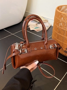 Sac à main cylindrique vintage en cuir verni marron avec bandoulière et boucles métal