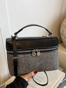 Chic herringbone tweed box bag with black leather flap and adjustable shoulder strap