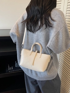 Creamy white vintage style shoulder bag with leather strap buckle and top handles