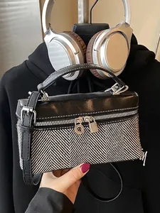 Contrast camera bag with black leather and herringbone pattern with silver hardware