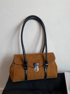 Brown suede underarm shoulder bag with black leather handle and silver metal lock clasp