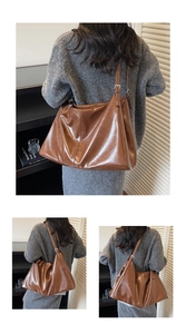 Detail shot of brown soft PU tote bag featuring a pleated texture and adjustable buckle strap