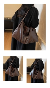 Detailed view of deep brown polished PU leather tote bag with adjustable shoulder strap