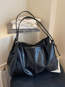Minimalist black large-capacity leather tote bag with adjustable silver buckle strap