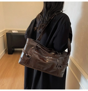 Brown oil wax leather tote bag shown on shoulder to illustrate large capacity and size
