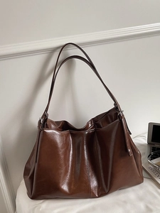 Deep brown large tote bag in glossy leather with double straps for daily commuting
