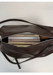 Top view of spacious dark brown crossbody bag interior showing large storage capacity