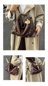 Detail of vintage brown wax leather backpack with white stitching and metal buckles