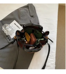 Top view of spacious interior in a contrast bucket bag holding phone and wallet