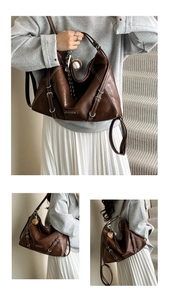 Close-up of brown tote bag featuring contrast stitching and baseball pendant detail