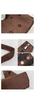 Detail of brown faux suede tote bag featuring laser-cut floral patterns and fine stitching