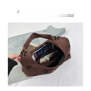 Detail showing high capacity interior of hollow out suede tote bag for daily essentials