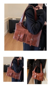 Detail of vintage brown leather tote bag showing double front pockets and metallic buckles