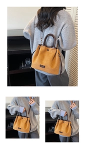Detail of faux suede bucket bag showing drawstring closure and brown handle texture