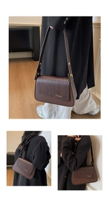 Detail view of brown leather bag with woven texture flap and gold fashion logo