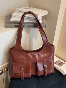 Vintage brown shoulder bag with dual front pockets and silver buckles for daily commute