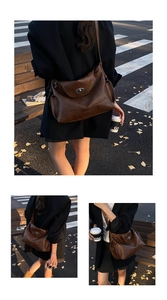 Detailed view of a vintage brown tote bag featuring a twist-lock closure and side pockets