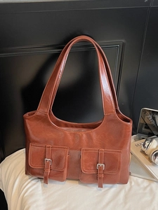 Vintage brown leather tote bag with dual front pockets and silver buckles for women