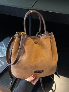 Caramel suede bucket bag with leather handles and drawstring, ideal for daily casual wear