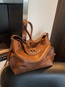 Retro brown leather tote bag with silver twist lock and side pockets for women