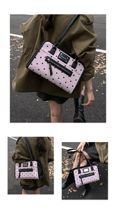 Detailed view of vintage pink polka dot tote bag with metal nameplate and zipper pocket