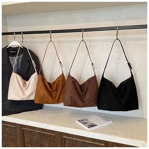 Detailed display of suede hobo shoulder bags in beige, brown, coffee, and black