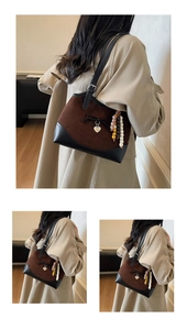 Detail of vintage leopard shoulder bag featuring suede texture and ethnic beaded charms