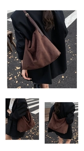 Macro detail of dark brown suede tote bag with leather strap and metal buckle adjustment