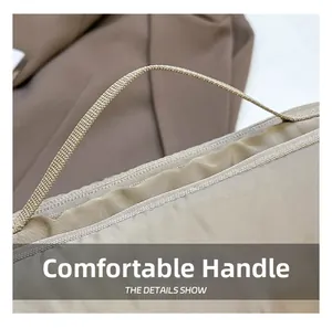 Détail de la poignée de sac cabas matelassé kaki avec coutures et texture tissée