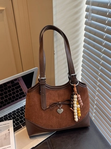 Brown patchwork suede and leather shoulder bag with bow and beaded charm for work