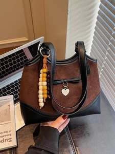 Leopard patchwork suede shoulder bag with heart pendant and wooden bead handle