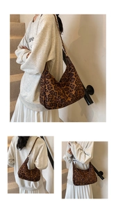 Macro view of leopard print hobo bag with gold chain strap and brown leather details