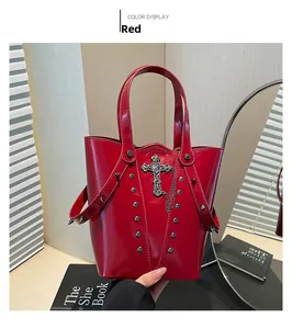 Detail of red punk bucket bag featuring silver metal crosses, rivets and chain accents