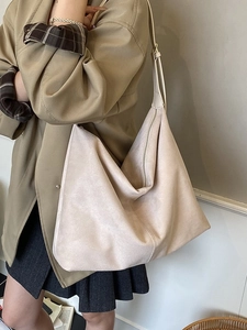 Large beige tote bag made of high-quality faux suede shown on a model for daily commute