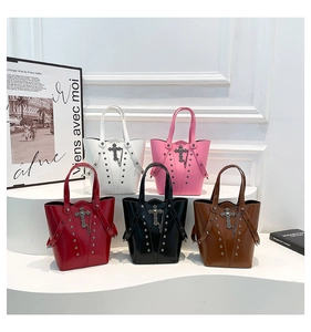 Detail showing bucket bags with chrome crosses and metal rivets in five colors