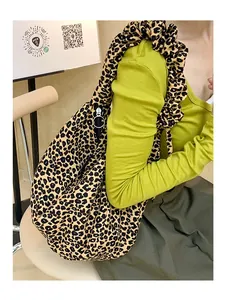 Detailed view of leopard print tote bag with ruffled shoulder strap and metal zipper detail