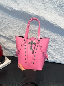 Vibrant hot pink punk bucket bag with silver studs and gothic cross pendant detail