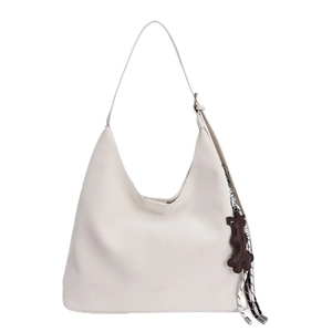 White minimalist leather hobo tote bag with brown bear charm and striped tassel detail