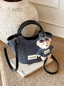 Sac seau en jean bleu avec poignée noire, bandoulière et pendentif ours en peluche
