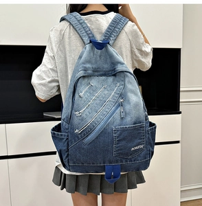 Detailed back view of vintage gradient denim backpack featuring distressed frayed denim texture