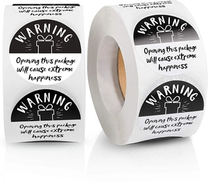 Detail of round black and white warning stickers for gift packages with extreme happiness text