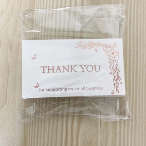 Stack of white Thank You cards with rose gold floral design in clear packaging