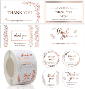 Macro detail of rose gold foil Thank You stickers and business cards for gift packaging