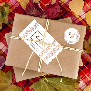 Floral gold foil Thank You stickers and cards on kraft packaging with autumn leaves