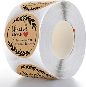 Detail of round kraft paper stickers with Thank You text and red heart on a roll
