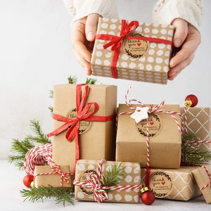 Macro shot of Kraft thank you labels on gift boxes with festive holiday decorations