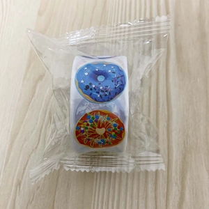 Macro detail of colorful doughnut incentive stickers on a roll with protective plastic film