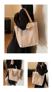 Detail of oatmeal corduroy tote bag with cream leather piping and reinforced corners