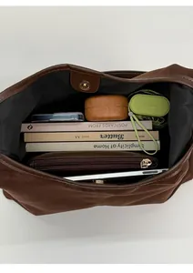 Vue intérieure du cabas en daim marron montrant la grande capacité pour tablette et effets